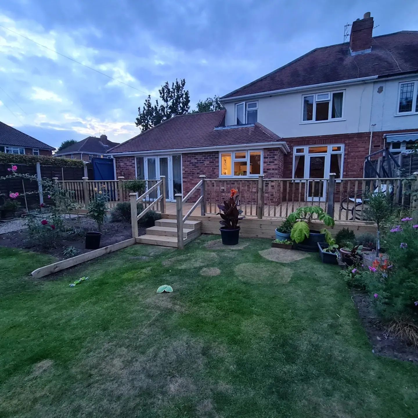Raised garden deck with steps and lighting